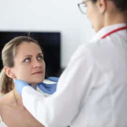 Doctor examining a woman's glands