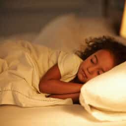 Young girl sleeping in bed