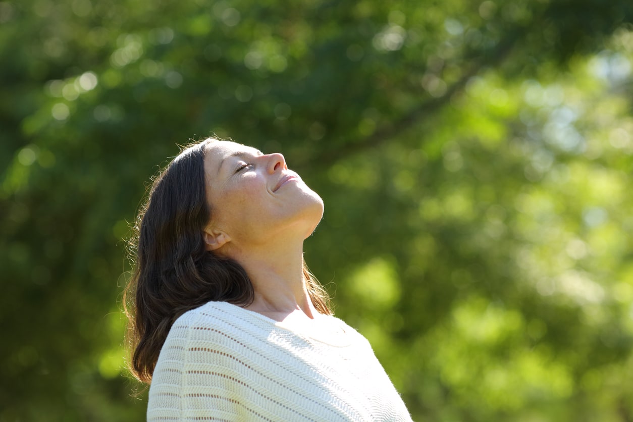 Woman breathing fresh air in the park.