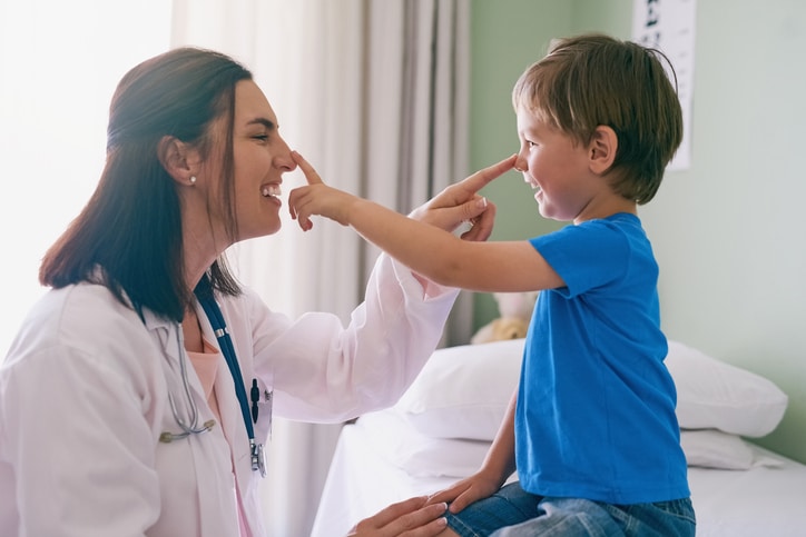 Child playing with the doctor at an allergy testing appointment