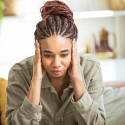 Anxious woman holding her temples